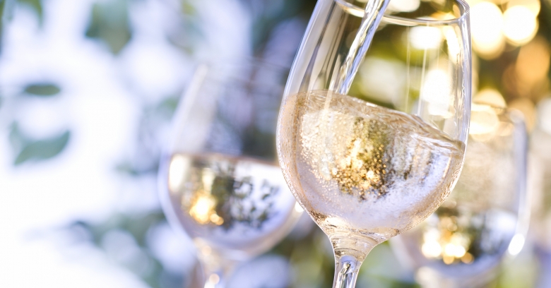 Three wine glasses filled with sparkling wine