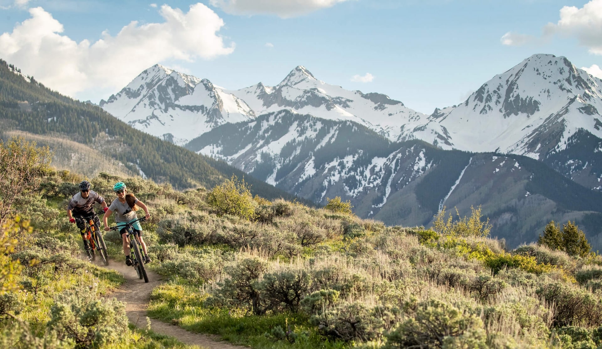 A couple biking on a path in the mountains