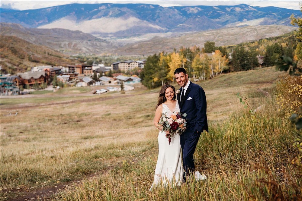 Bride and groom on hillside