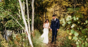 Bride and groom walking in the forest