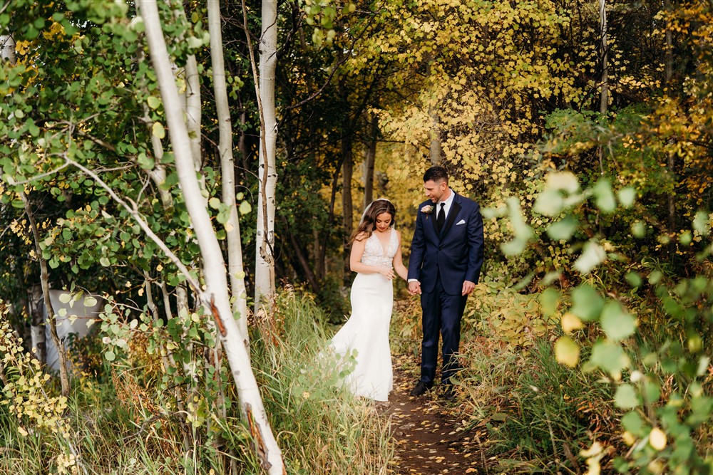 Bride and groom walking in the forest