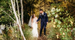 Bride and groom walking in the forest