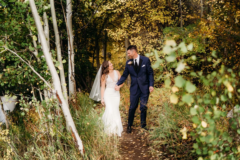 Bride and groom walking in the forest