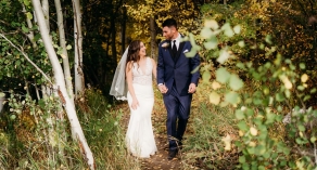 Bride and groom walking in the forest