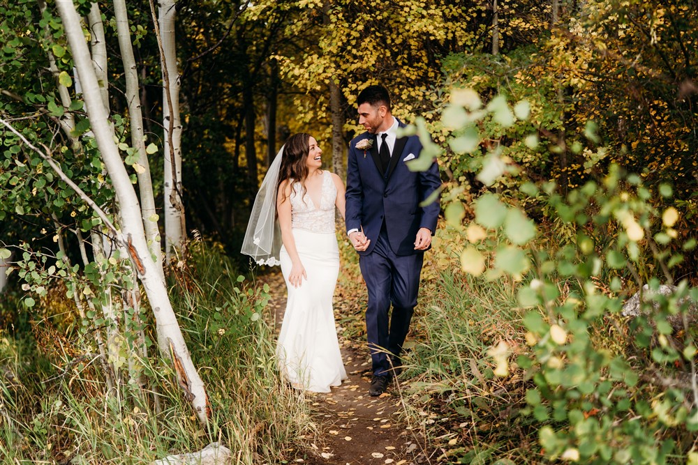 Bride and groom walking in the forest