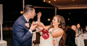 Bride feeding groom cake