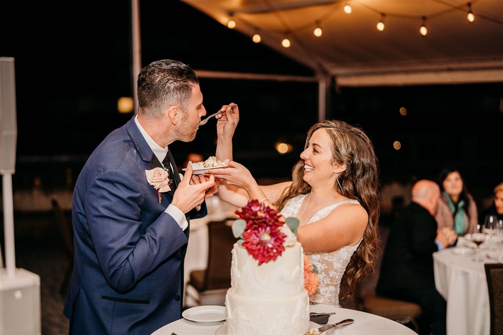 Bride feeding groom cake