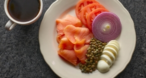 plate of smoked salmon. tomatoes, red onions, eggs, and capers