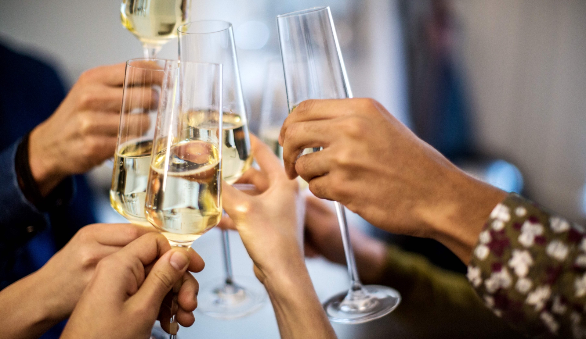 group close up of hands with glasses of champagne