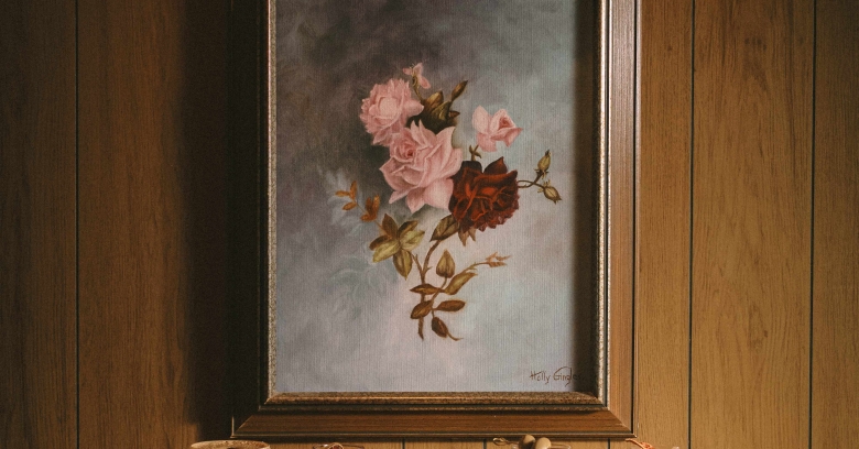 line-up of cocktails underneath painting of flowers